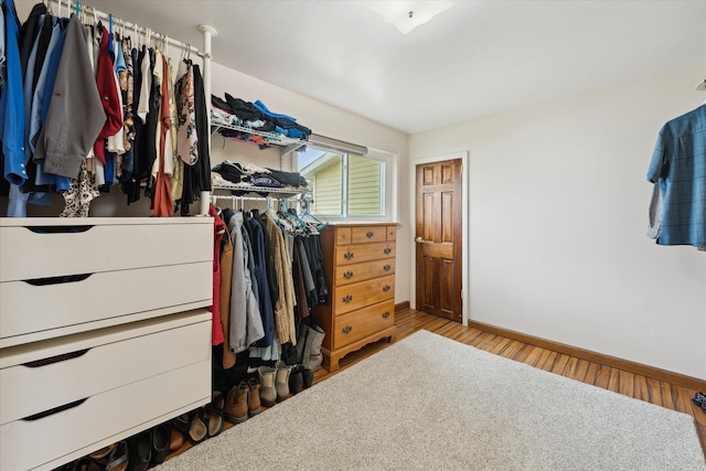 walk in closet featuring wood finished floors