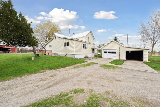 view of property exterior with a lawn, a garage, and an outbuilding