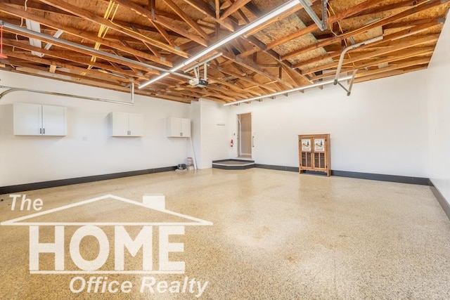 garage featuring baseboards and a garage door opener