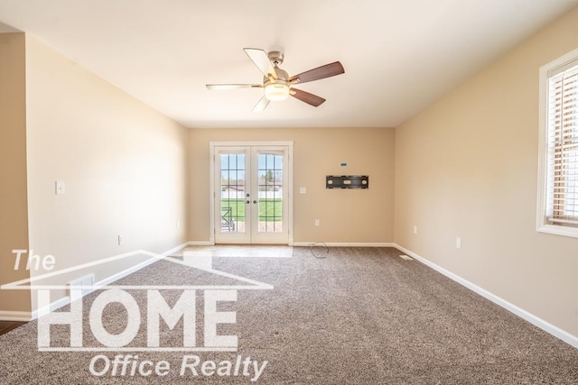 spare room featuring a ceiling fan, carpet floors, french doors, and baseboards
