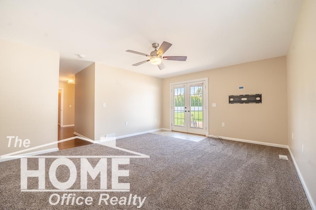 carpeted empty room with a ceiling fan, french doors, and baseboards