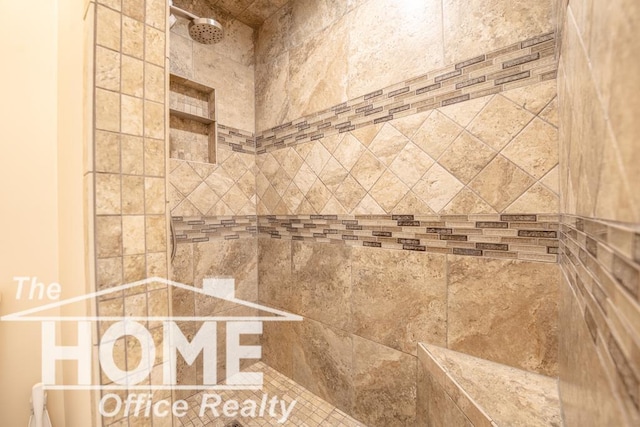 interior details featuring tiled shower