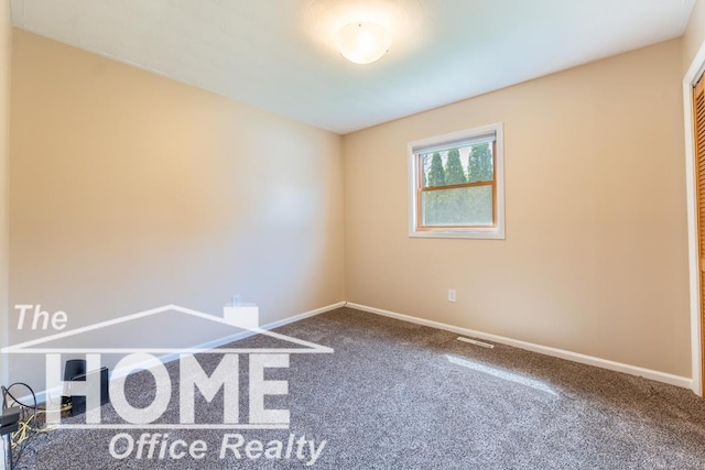 spare room with visible vents, carpet flooring, and baseboards