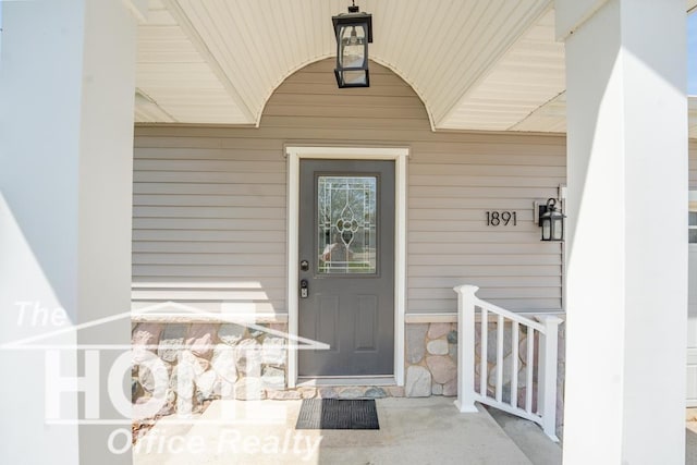 view of exterior entry featuring a porch