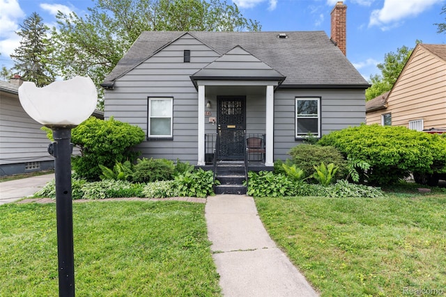 20186 Monte Vista St, Detroit, MI 48221 - bungalow-style home with a front yard, a shingled roof, and a chimney