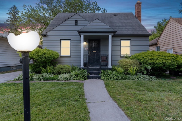 20186 Monte Vista St, Detroit, MI 48221 - bungalow-style home featuring a front yard, roof with shingles, and a chimney