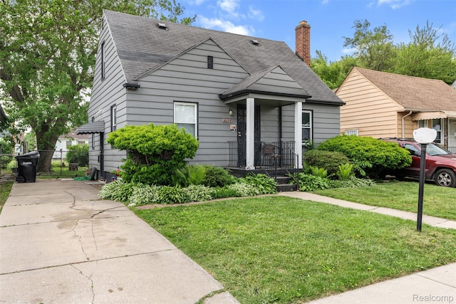 20186 Monte Vista St, Detroit, MI 48221 - view of front of home with a shingled roof and a chimney