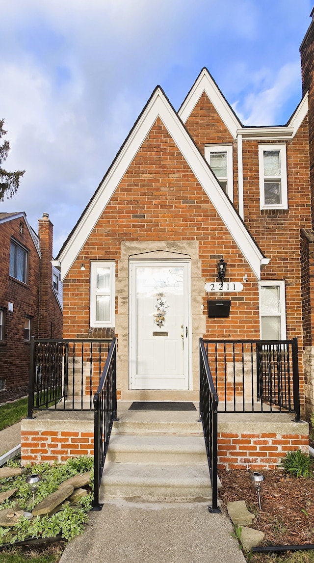 view of front facade with brick siding and a porch