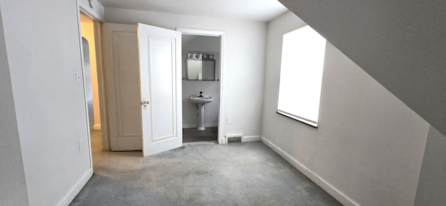 unfurnished bedroom featuring visible vents, carpet, and baseboards