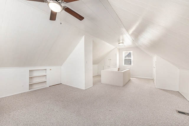 additional living space with lofted ceiling, carpet flooring, ceiling fan, visible vents, and built in features