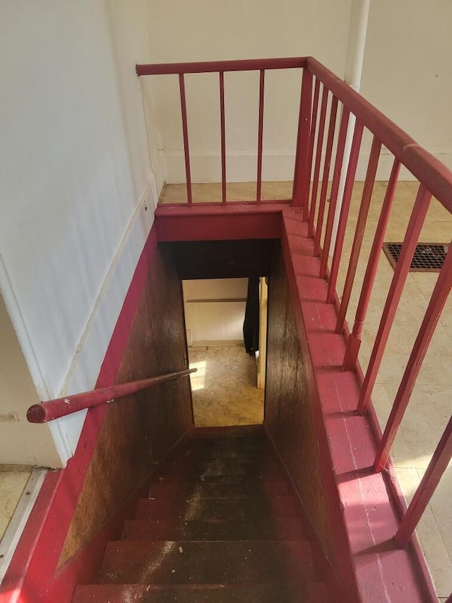 stairs featuring wood finished floors