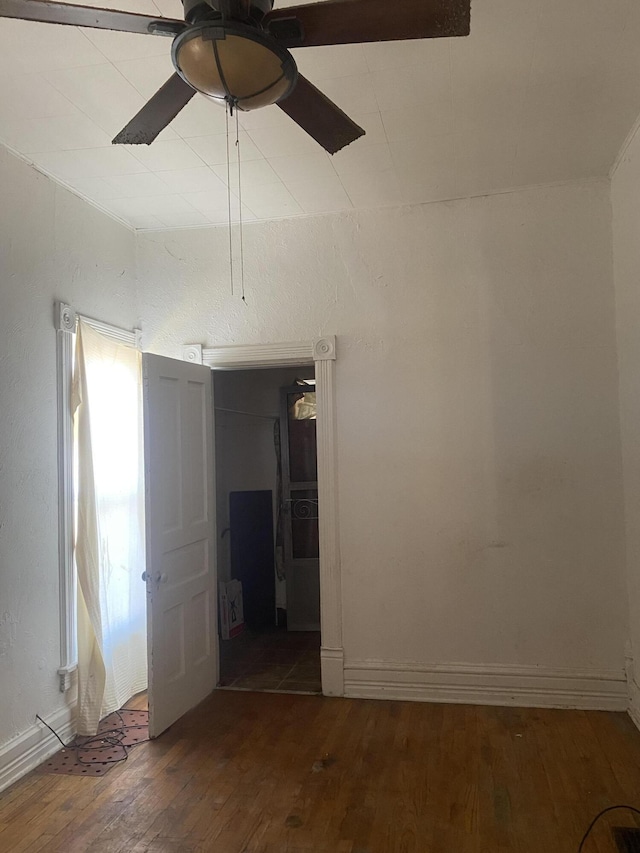 spare room with ceiling fan and wood finished floors