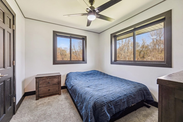 bedroom featuring baseboards, ceiling fan, and carpet
