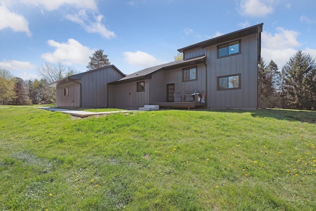 back of property with a yard and board and batten siding