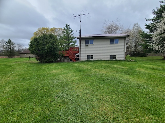 24800 Dayton Rd, Armada, MI 48005 - rear view of house featuring metal roof, a deck, a yard, and stairway