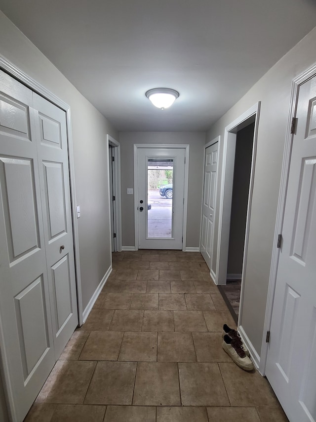 24800 Dayton Rd, Armada, MI 48005 - doorway to outside featuring dark tile patterned floors and baseboards