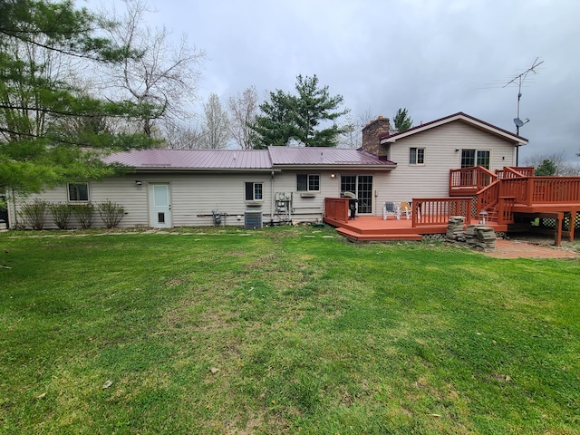 24800 Dayton Rd, Armada, MI 48005 - back of property featuring a deck, a chimney, metal roof, and a lawn