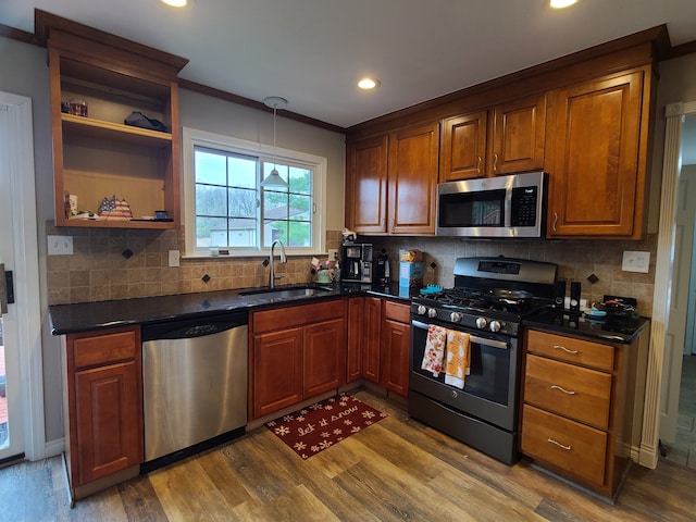 24800 Dayton Rd, Armada, MI 48005 - kitchen featuring a sink, appliances with stainless steel finishes, dark countertops, dark wood-style flooring, and recessed lighting