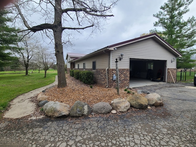 24800 Dayton Rd, Armada, MI 48005 - view of home's exterior with a garage, brick siding, driveway, and a lawn