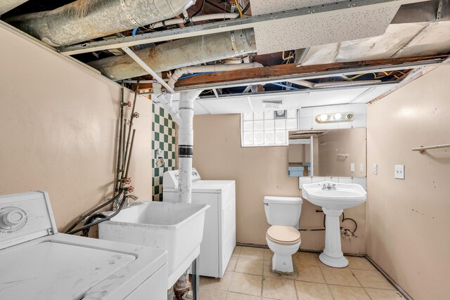 5281 Middlesex St, Dearborn, MI 48126 - clothes washing area with light tile patterned floors, a sink, laundry area, and washing machine and dryer
