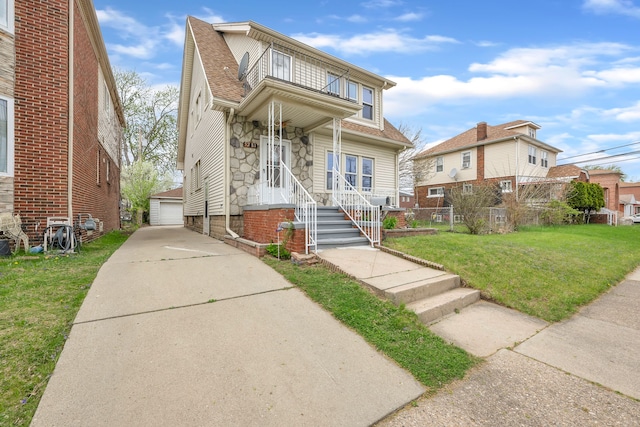 5281 Middlesex St, Dearborn, MI 48126 - view of front facade with stone siding, a detached garage, a shingled roof, an outbuilding, and a front lawn