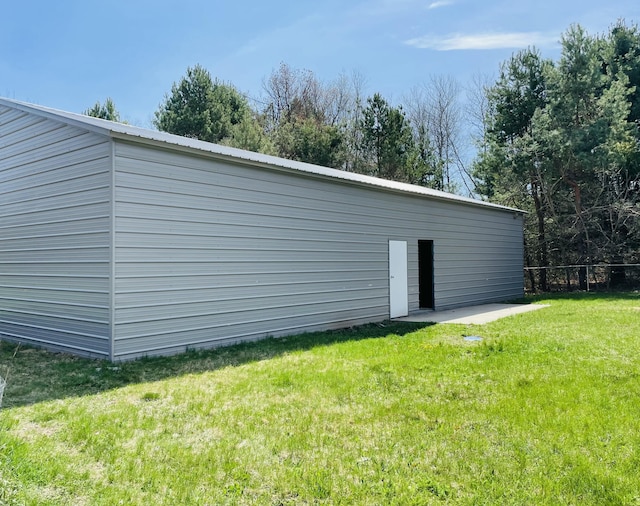 view of outbuilding with fence