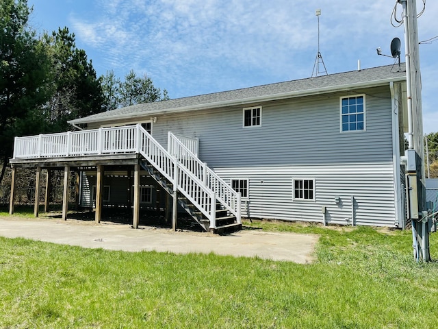 back of property with stairs, a lawn, a deck, and a patio
