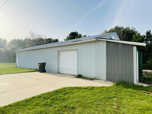 detached garage with concrete driveway