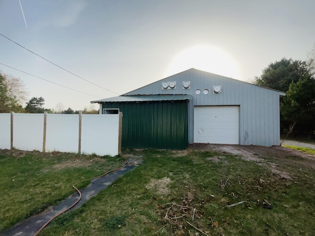 detached garage featuring fence
