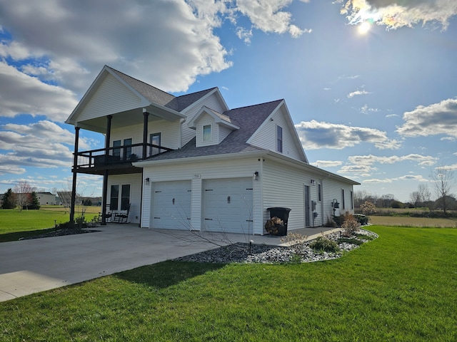 view of home's exterior featuring a garage, a yard, a shingled roof, and a balcony