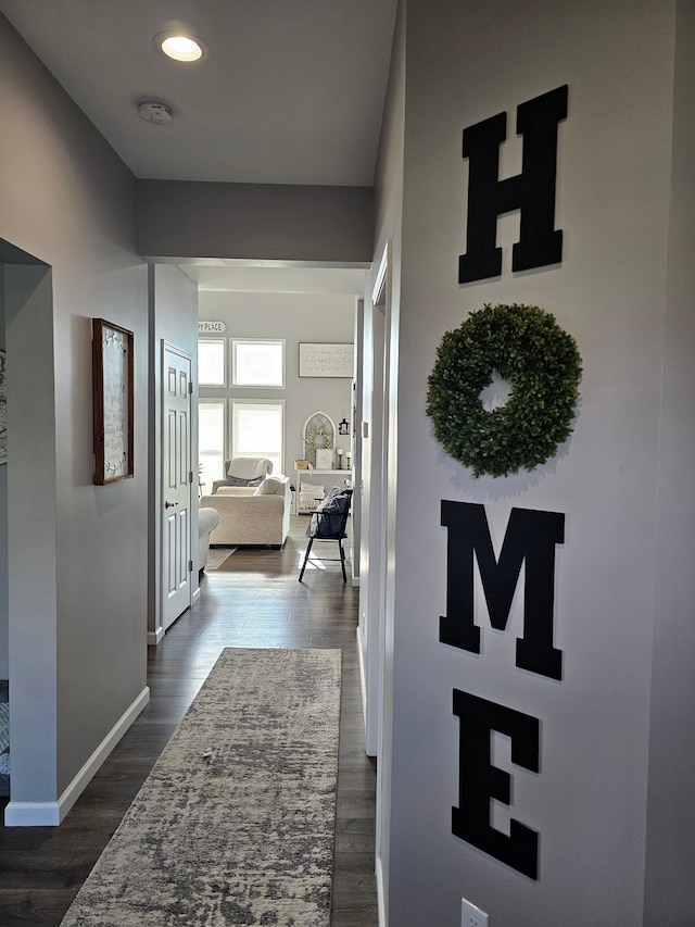 corridor featuring baseboards, recessed lighting, and dark wood-style floors
