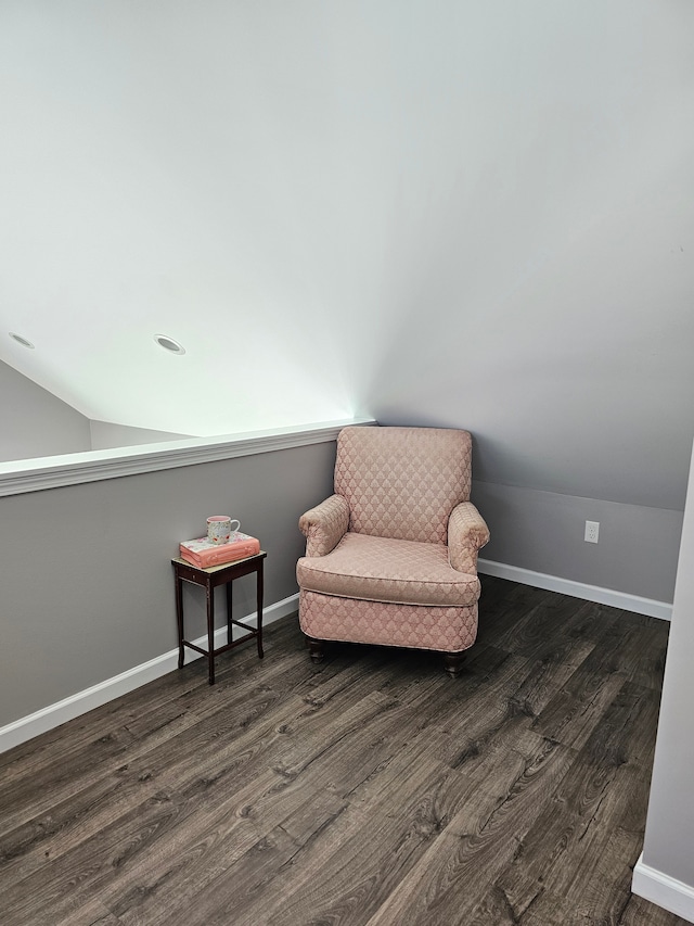 sitting room featuring lofted ceiling, dark wood finished floors, and baseboards