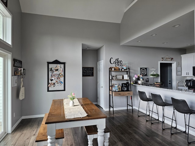 dining space featuring wood finished floors and baseboards
