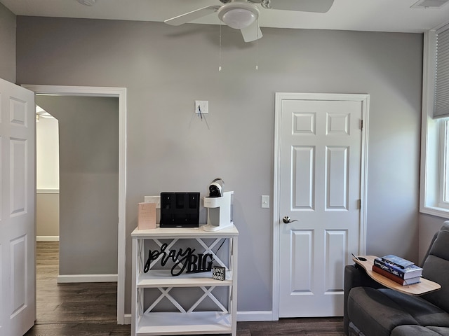 office area with visible vents, a ceiling fan, dark wood-style floors, and baseboards