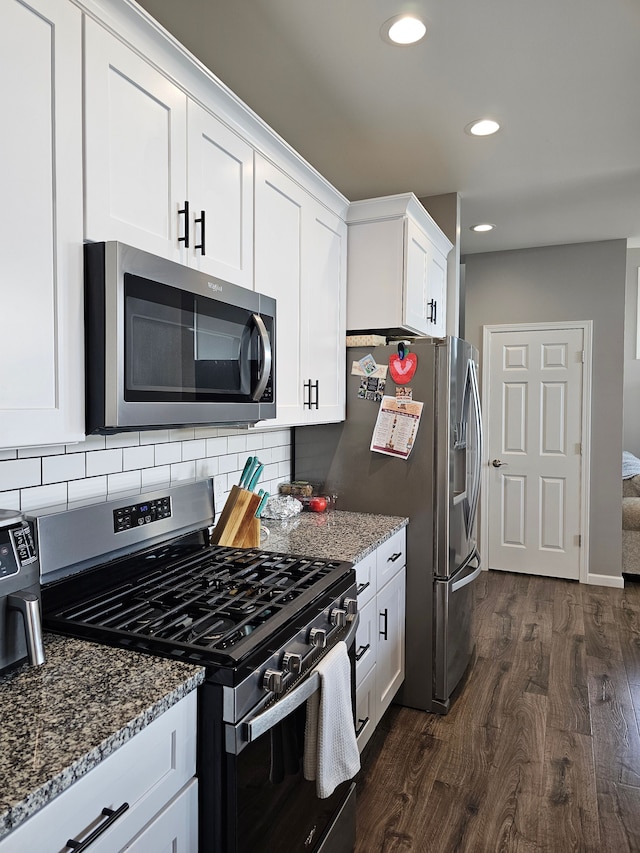 kitchen featuring dark wood-style floors, stone countertops, white cabinetry, and stainless steel appliances