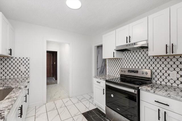 kitchen featuring light stone countertops, under cabinet range hood, stainless steel electric range oven, marble finish floor, and white cabinetry