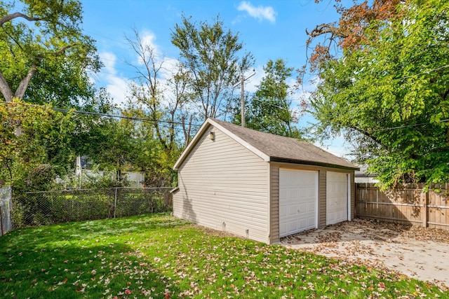 detached garage featuring fence