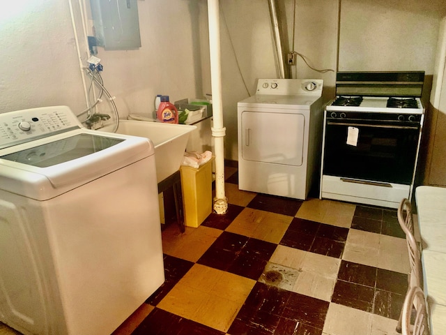 laundry room featuring separate washer and dryer, dark floors, and electric panel