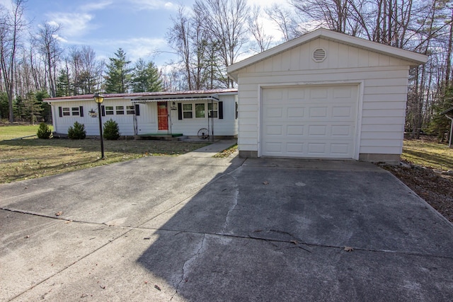 single story home with a garage, driveway, and a front lawn