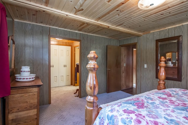 carpeted bedroom with wooden walls and wooden ceiling