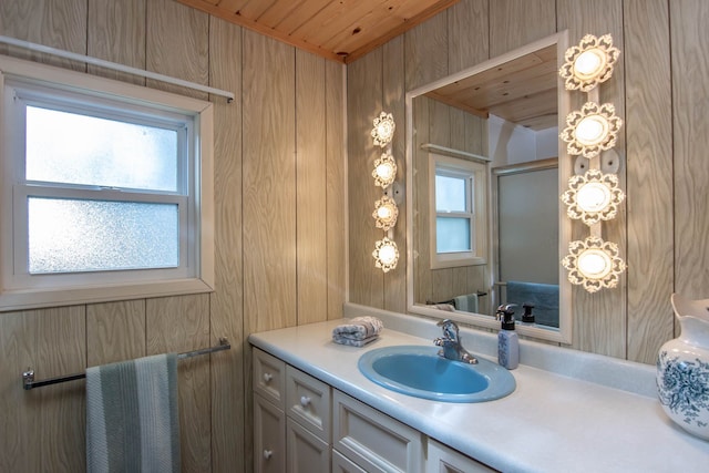 bathroom featuring wooden walls, wood ceiling, a shower with shower door, and vanity