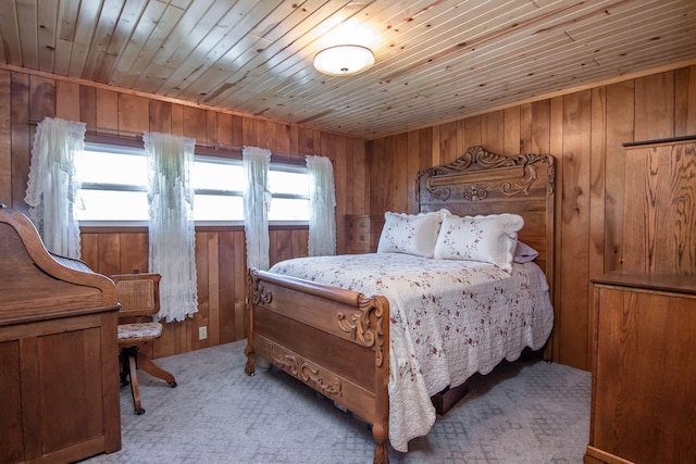 bedroom featuring wood walls, wood ceiling, and light carpet