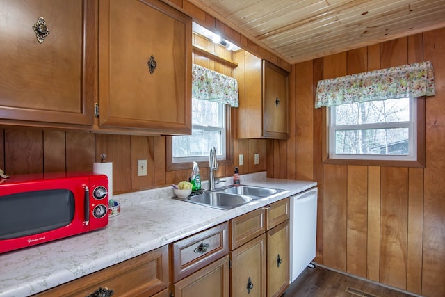 kitchen featuring brown cabinetry, a sink, and light countertops