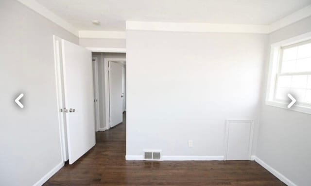 22613 Raven Ave, Eastpointe, MI 48021 - empty room featuring visible vents, baseboards, and dark wood-type flooring