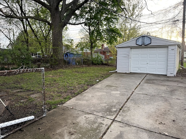 22613 Raven Ave, Eastpointe, MI 48021 - view of yard with a garage, fence, an outbuilding, and concrete driveway