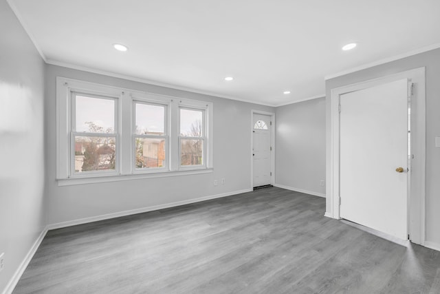 unfurnished living room with baseboards, recessed lighting, wood finished floors, and crown molding