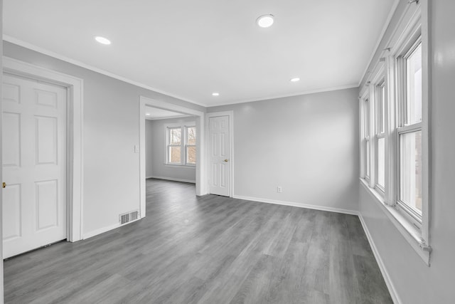 unfurnished room featuring recessed lighting, crown molding, visible vents, baseboards, and wood finished floors