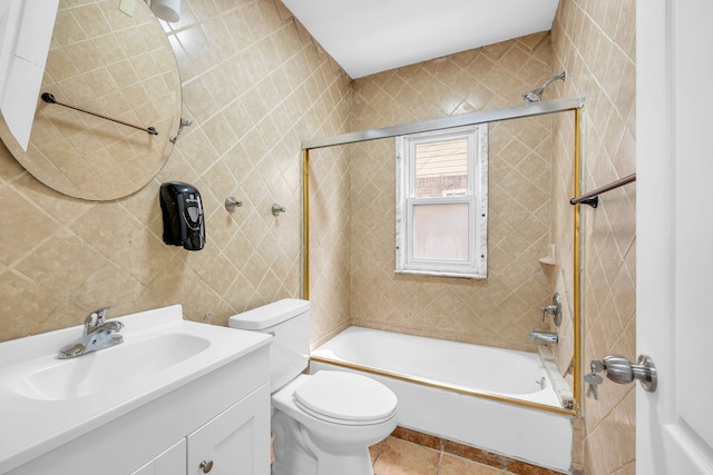 bathroom with toilet, tile patterned flooring, vanity, and shower / bathing tub combination
