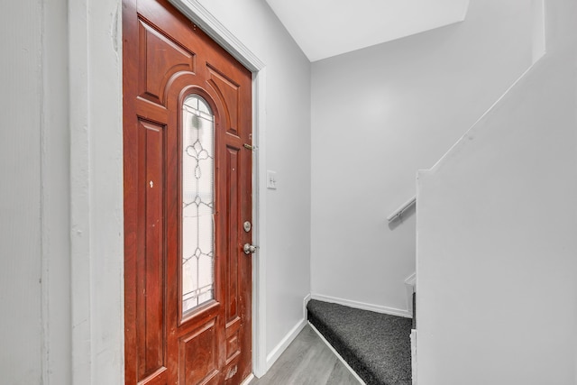 foyer entrance featuring light wood finished floors and baseboards