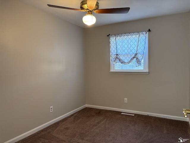 spare room with baseboards, visible vents, ceiling fan, and carpet flooring